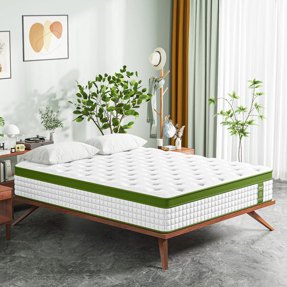 White hybrid mattress on bed frame with green border and quilted surface.