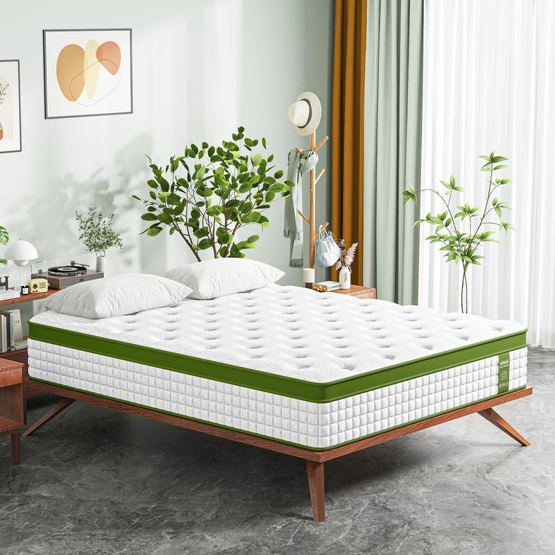 White hybrid mattress on bed frame with green border and quilted surface.