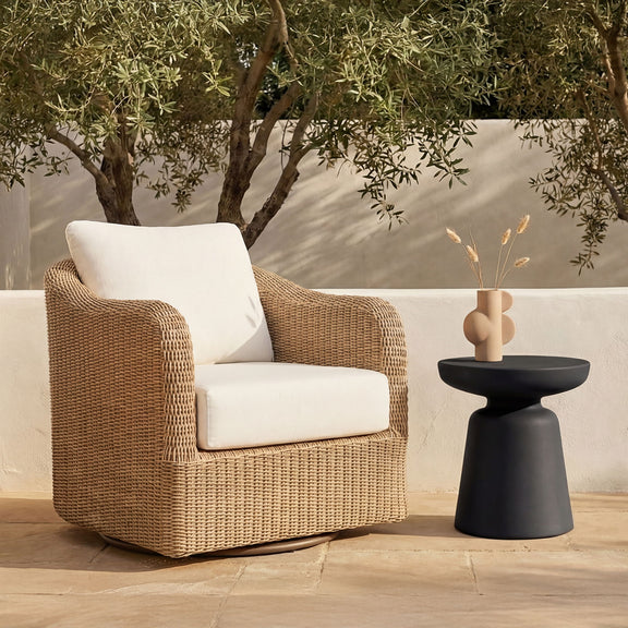 Black round-top outdoor side table with pedestal base next to patio seating