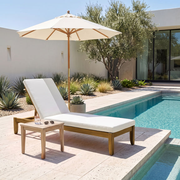 Adjustable patio chaise lounge with cream cushions and natural wood legs by poolside