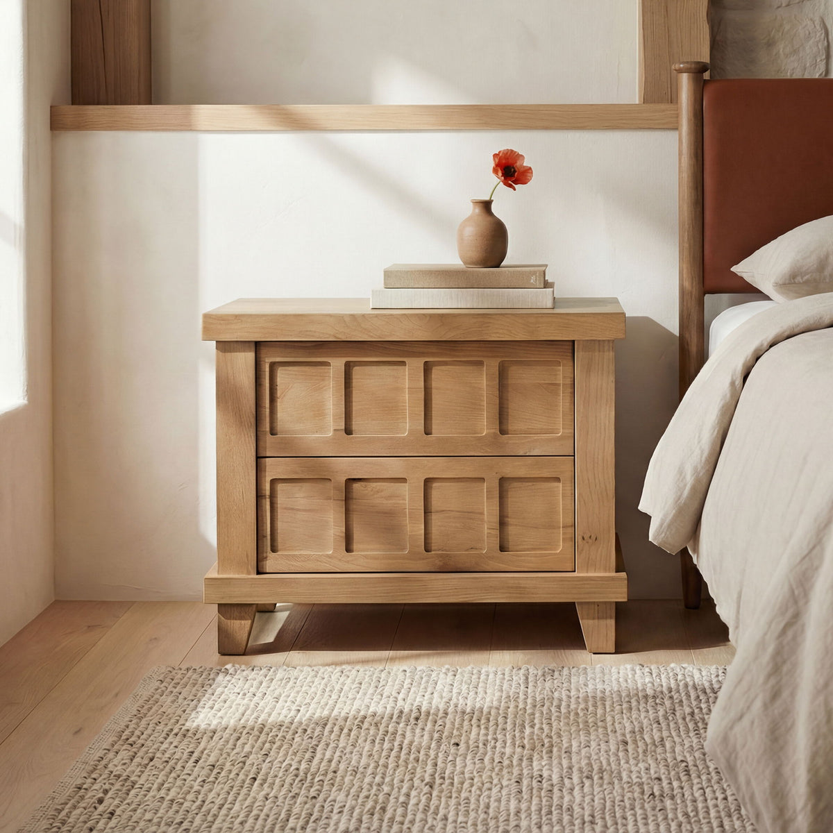 Natural oak nightstand with two drawers and small vase decor on top