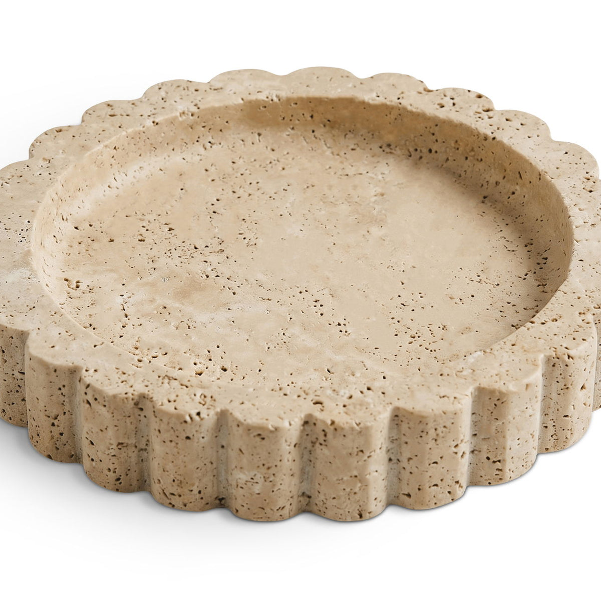 Beige travertine serving tray with scalloped rim and speckled stone texture