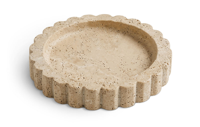 Beige travertine serving tray with scalloped rim and speckled stone texture