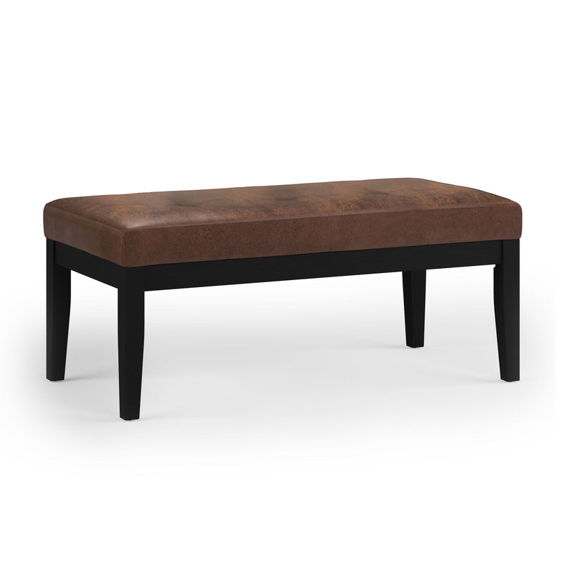 Dark brown upholstered tufted ottoman bench with smooth padded top and tapered legs