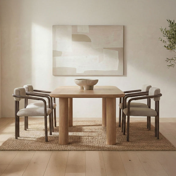 Natural wood small dining table with bowl centerpiece and four upholstered chairs