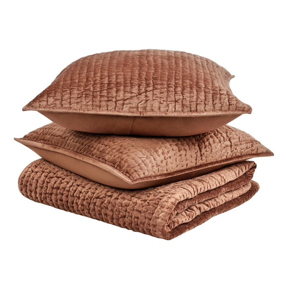 Terracotta velvet quilt set with folded quilt and matching decorative pillows