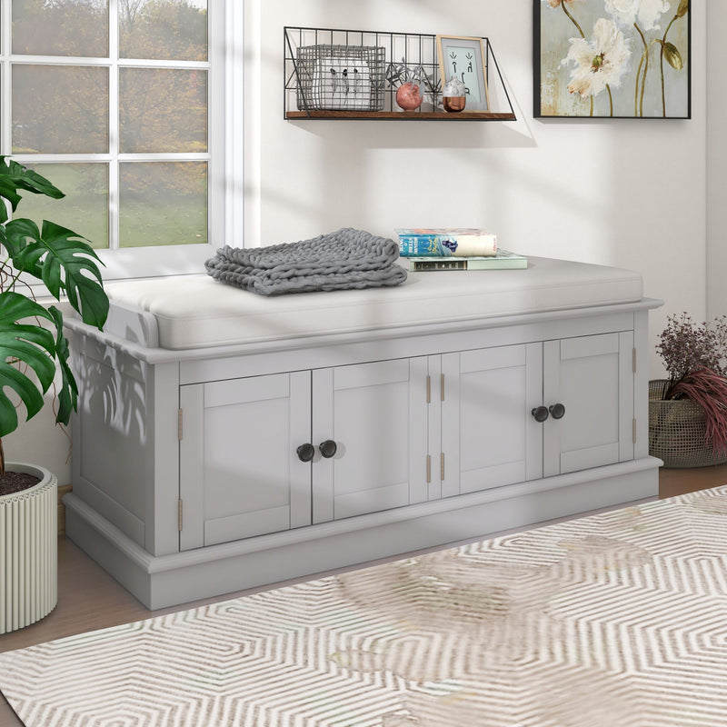 White four-door shoe storage bench with a padded removable cushion, shown at an angle