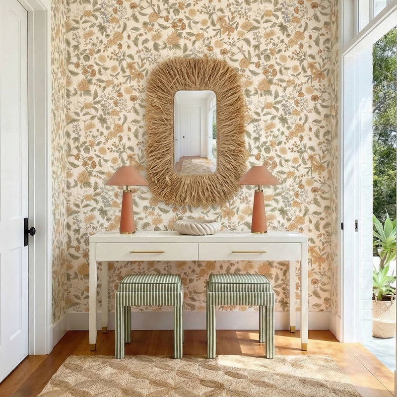 Cream console table with two drawers and gold bar pulls, styled in an entryway
