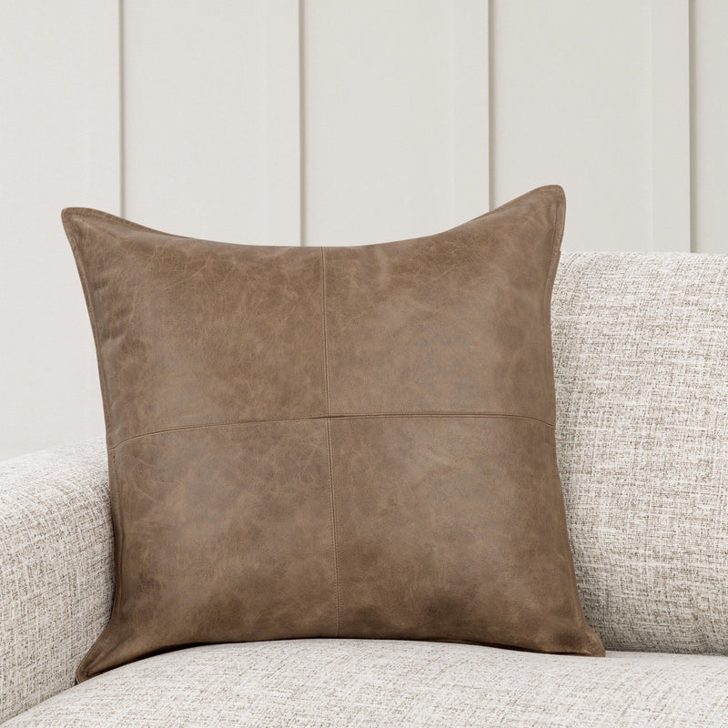 Brown leather accent pillow, square shape with stitched panel seams