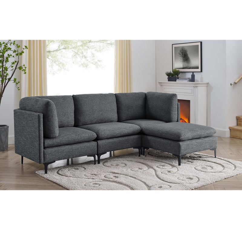 Dark gray modular sectional with ottoman and tall legs in a living space