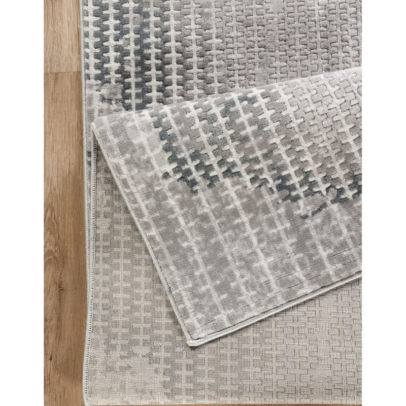 Gray area rug with woven 3D geometric pattern and textured pile detail.