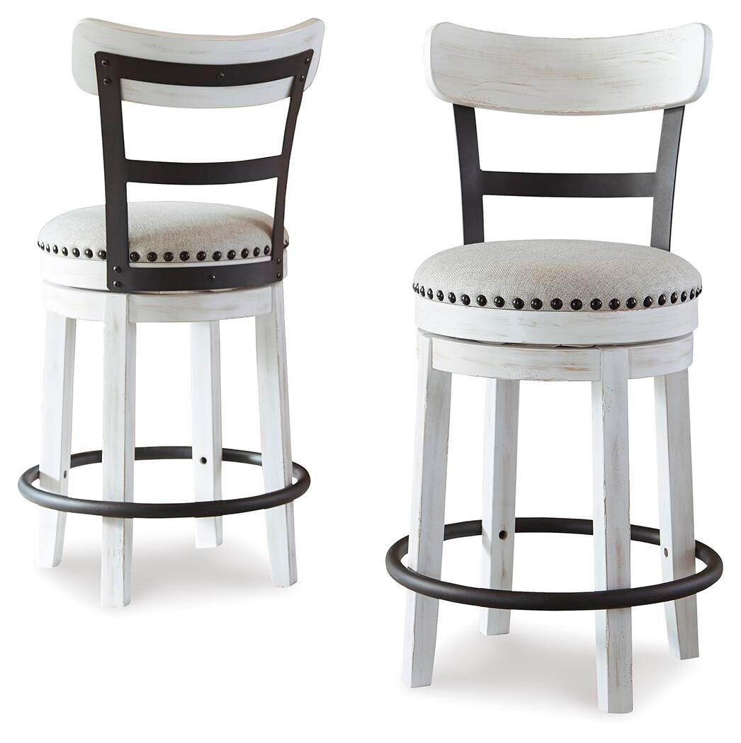 Pair of white swivel bar stools with studded round upholstered seats and black curved footrest rings