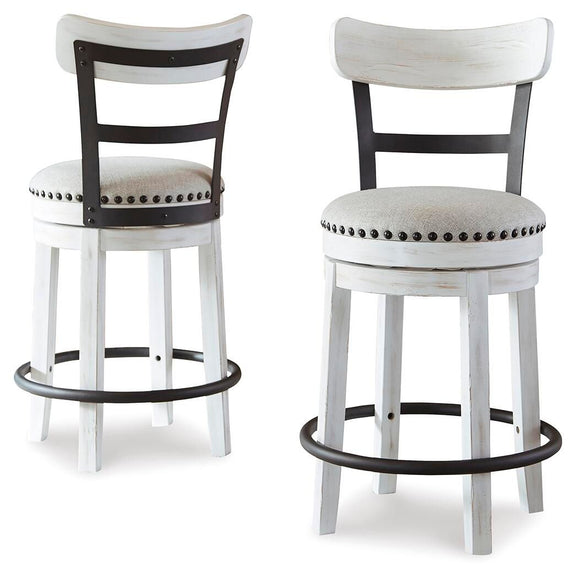 Pair of white swivel bar stools with studded round upholstered seats and black curved footrest rings