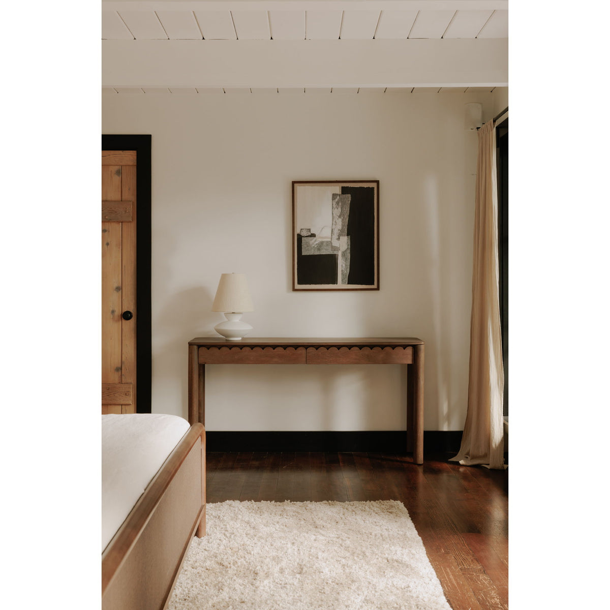 Vintage brown console table with wide top, scalloped apron, and open space below