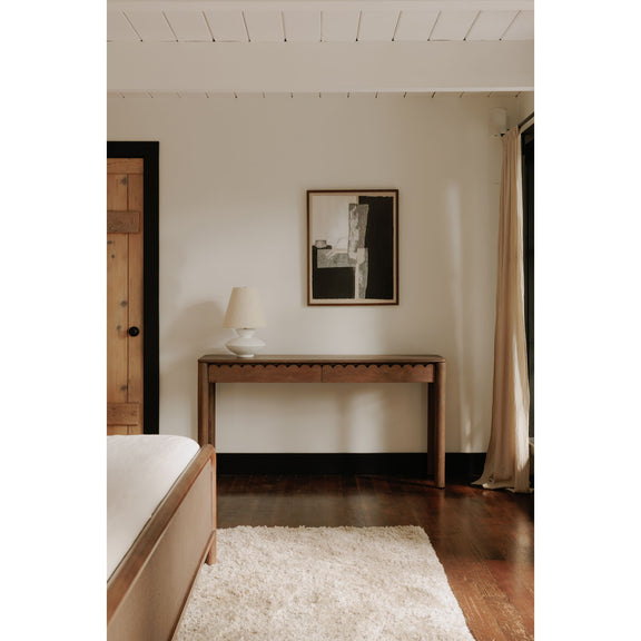 Vintage brown console table with wide top, scalloped apron, and open space below