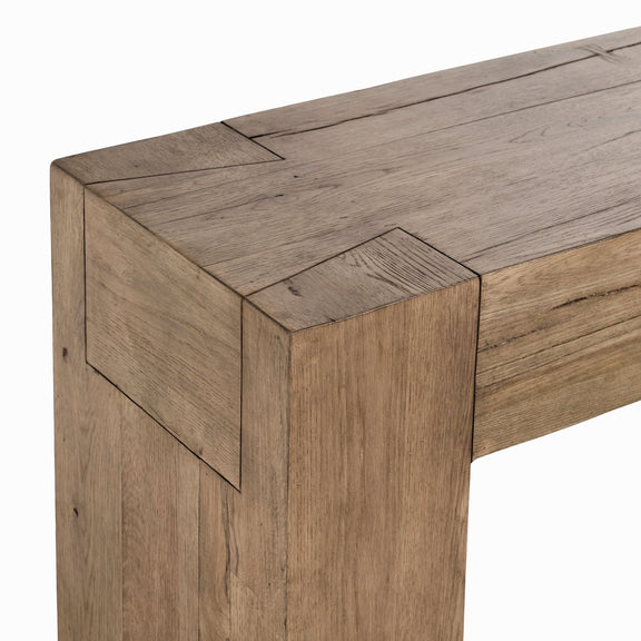 Reclaimed oak table corner with squared leg and weathered wood-grain details