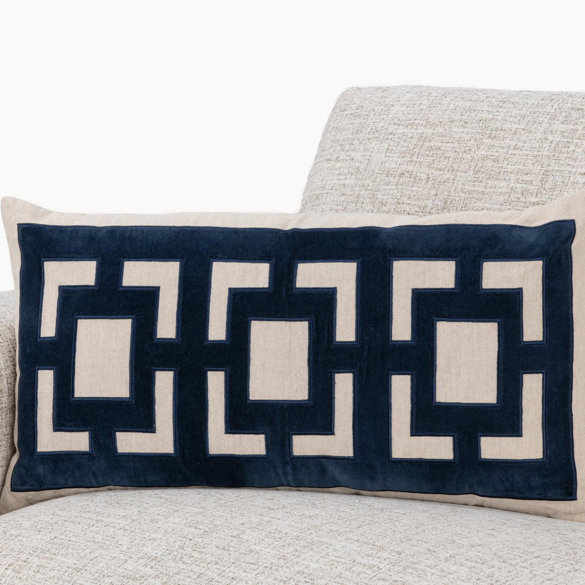 Rectangular pillow with navy geometric pattern and beige border