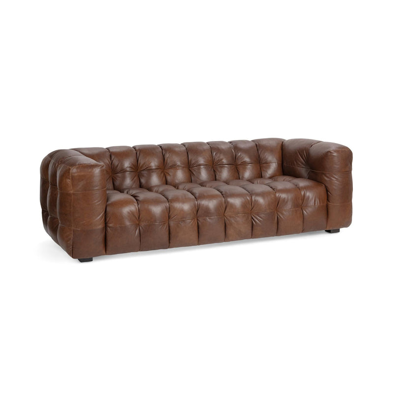 Chestnut-brown tufted leather sofa, wide side view with low square legs.