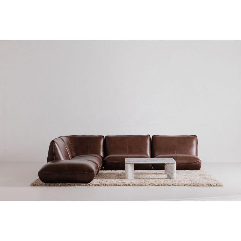 Gray marble-effect coffee table centered on rug in front of brown sofa
