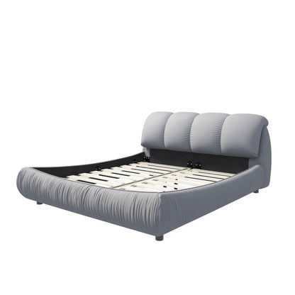 Gray upholstered platform bed with oversized padded backrest and slatted support frame