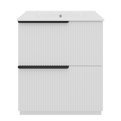 White freestanding bathroom vanity with fluted cabinet doors and white ceramic sink.
