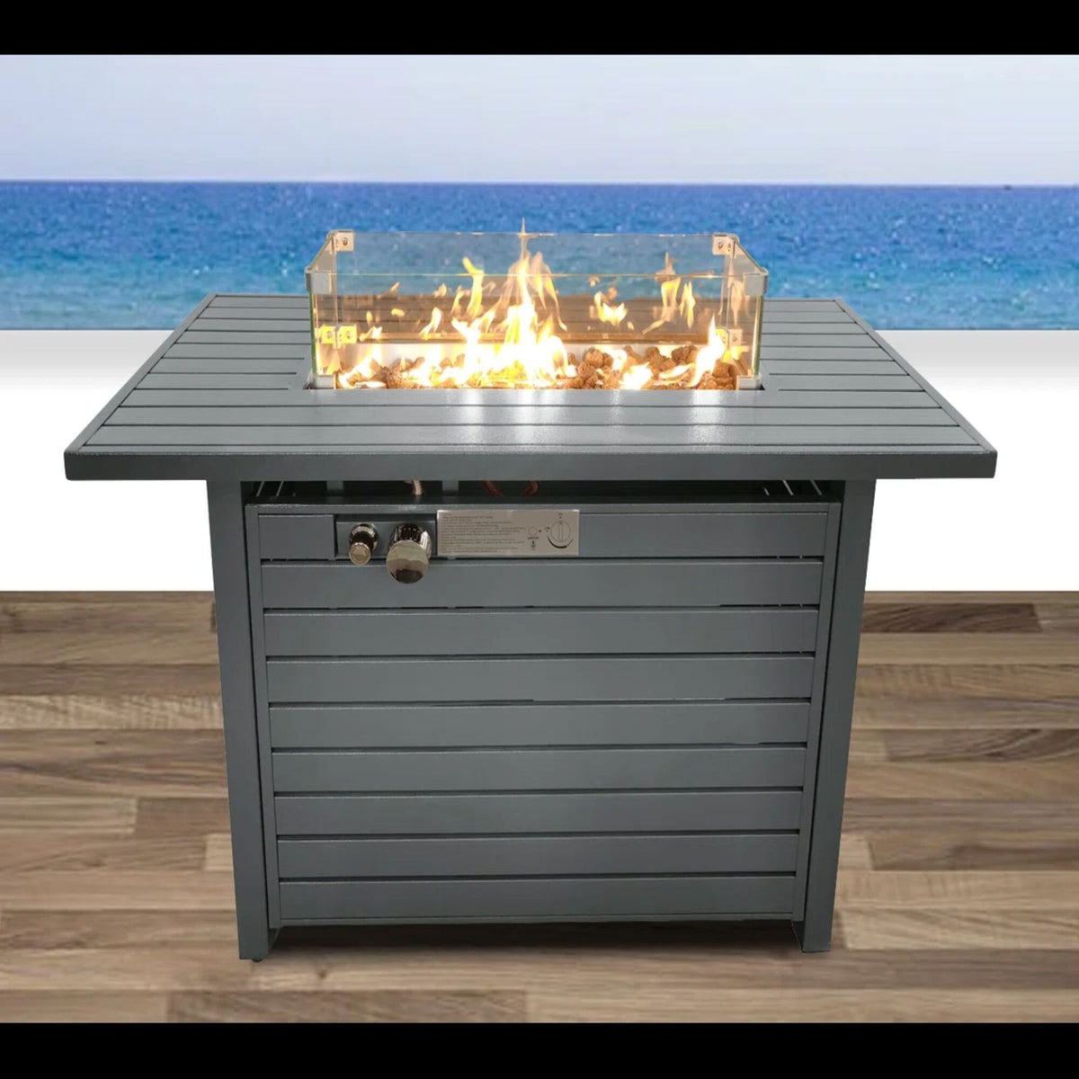 Gray propane fire pit table with open clear lid and front control knobs