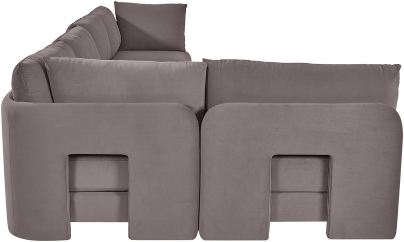 Gray velvet L-shaped sectional sofa with padded backrests and chaise seating