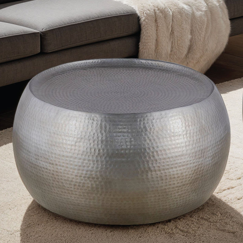 Silver hammered metal round coffee table with gray top surface