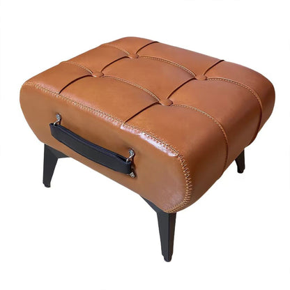 Minimalist footstool with hidden storage, orange tufted top and dark handle strap