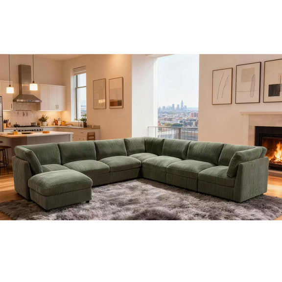 Dark green modular sectional sofa with chaise and matching ottoman for seating.