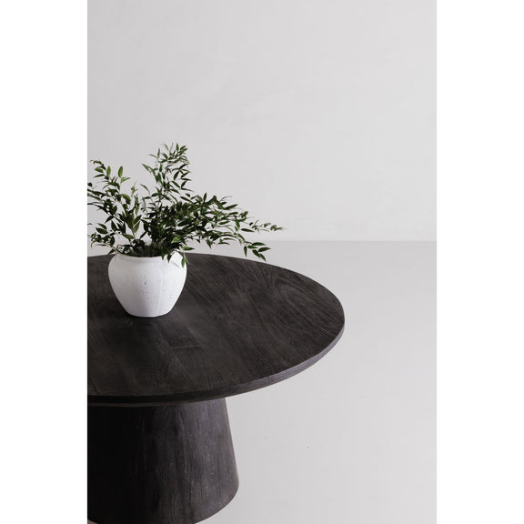 Cember round dining table close-up of dark wood top with potted plant