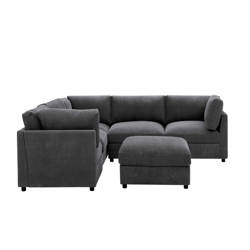 Dark gray modular sectional sofa with matching ottoman and rounded arm sections.