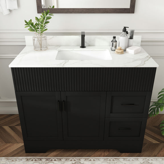 Black ribbed bathroom vanity with marble-look top, centered sink, cabinet doors and drawer