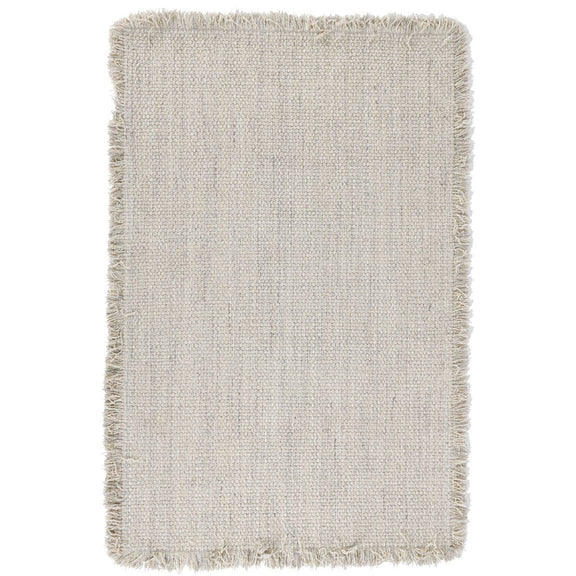 Ivory wool rug with short fringed edges and subtle woven texture.