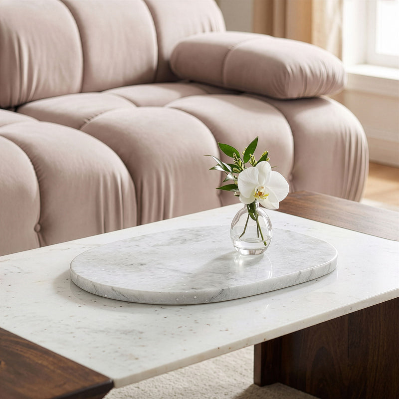 Round white marble decorative tray on a table with vase and flowers, top view