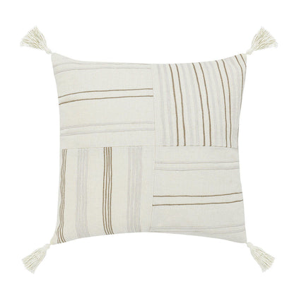 Ivory woven throw pillow with stitched stripes, patchwork blocks, and corner tassels