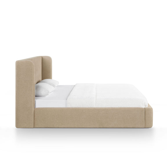 Beige upholstered platform bed with tall headboard and white bedding on top