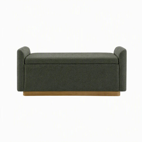 Dark green upholstered storage bench with cushioned lid and hinged safety support.