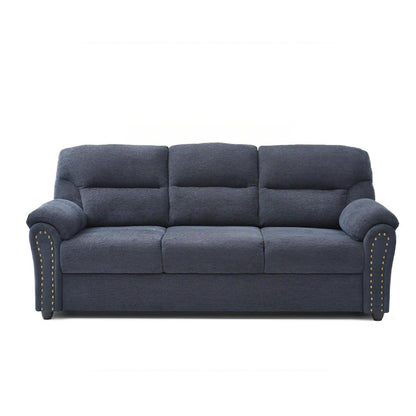 Blue sofa with nailhead trim along arms, tufted back panels and padded seat cushions.