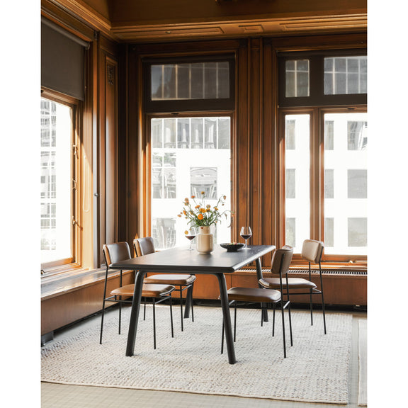 Brown dining chairs with curved backs, padded seats, and black metal frames