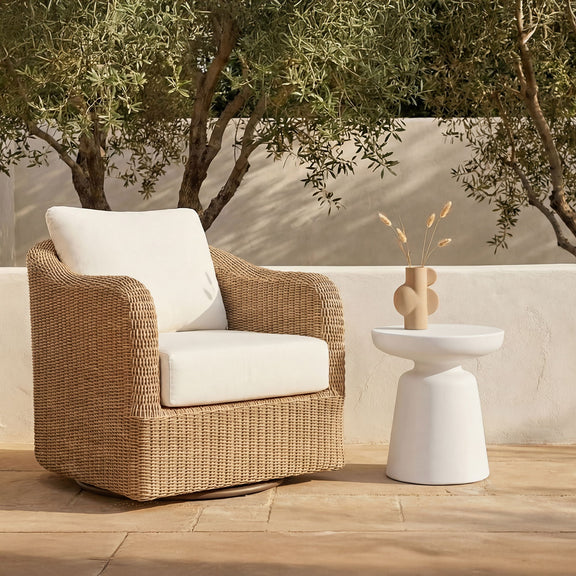 White pedestal side table with round top, shown outdoors