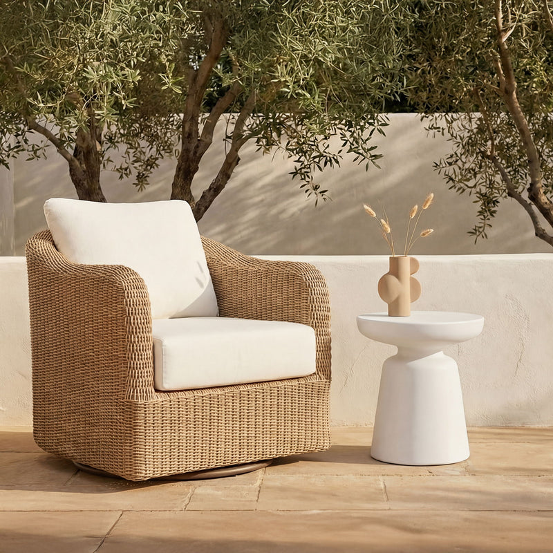White pedestal side table with round top, shown outdoors
