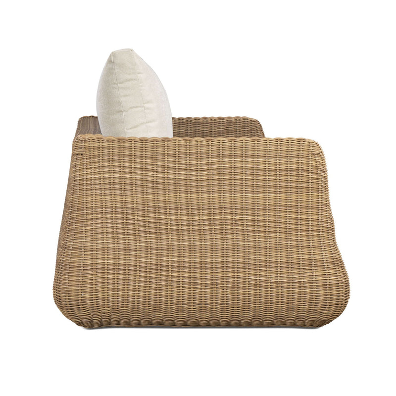 Outdoor sofa back view with white back pillow on brown woven wicker frame