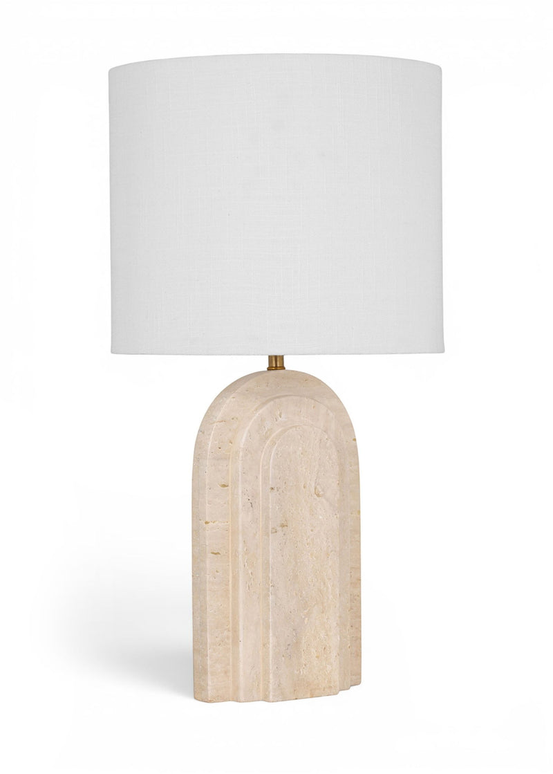 Table lamp with white fabric shade and beige textured stone base with gold stem