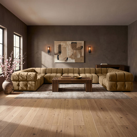 Light brown velvet sectional sofa with tufted cushions and rounded chaise corner ends
