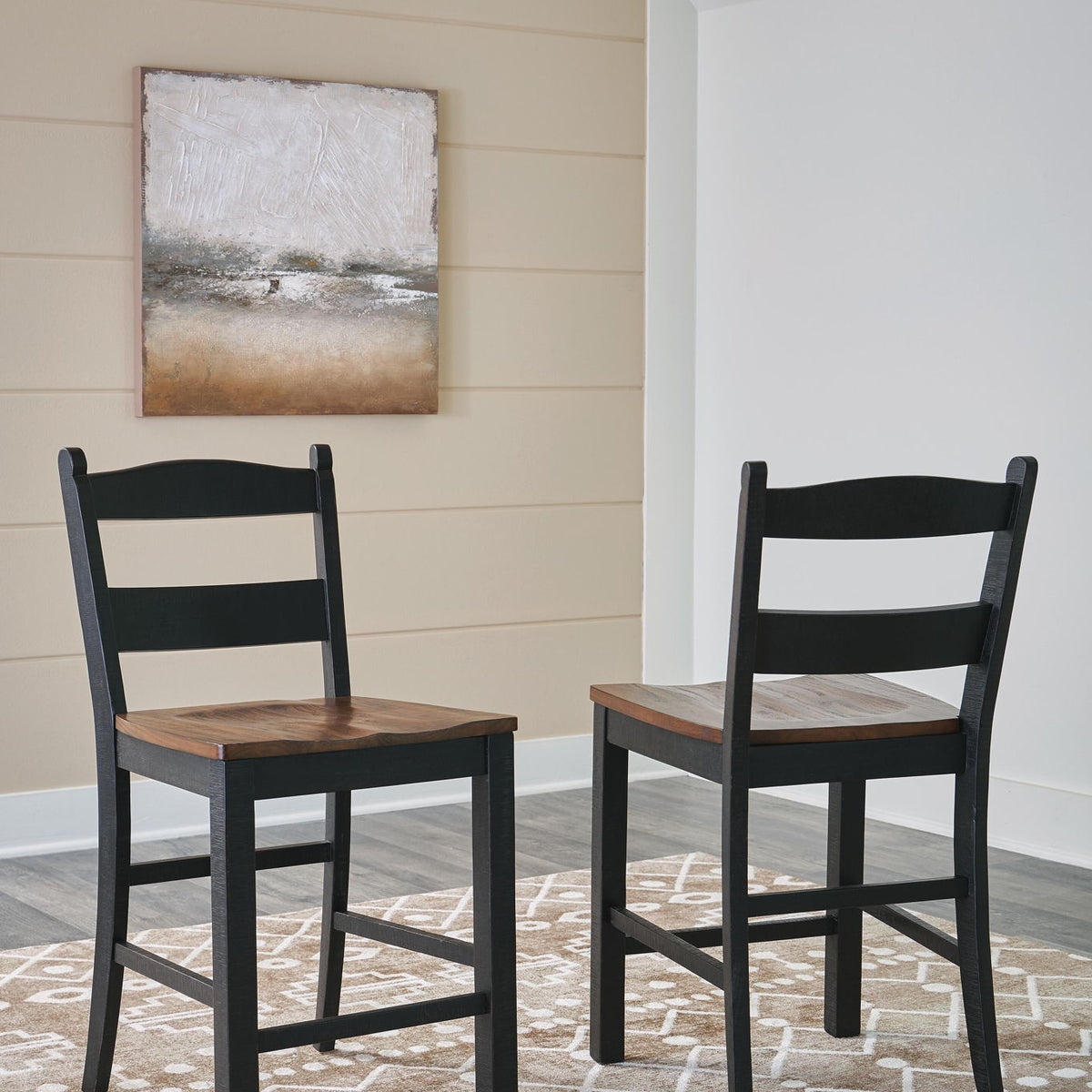 Two black barstools with brown square seats and ladder backs