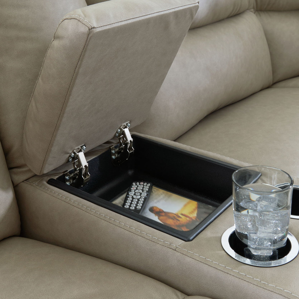 Gray power reclining sectional with open storage console, remote controls, and cup holder
