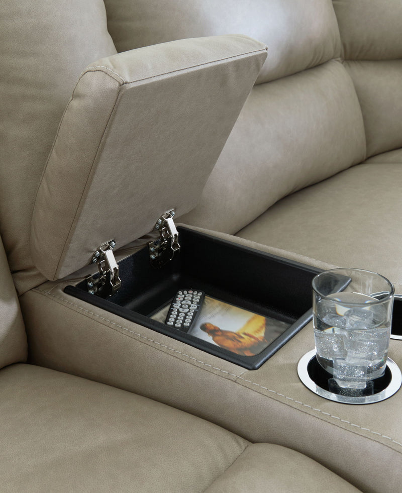 Gray power reclining sectional with open storage console, remote controls, and cup holder