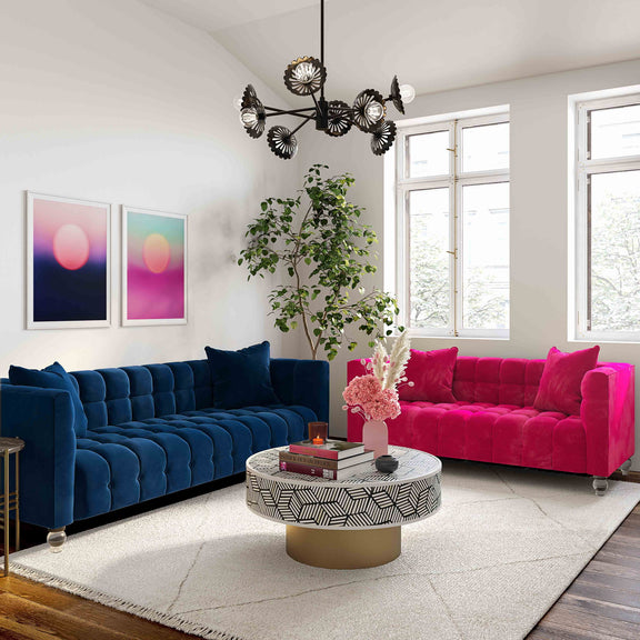 Blue and pink velvet sofas with tufted backs and cushions, square legs