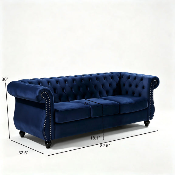 Blue three-seat button-tufted sofa, side view with rolled arms and stud trim